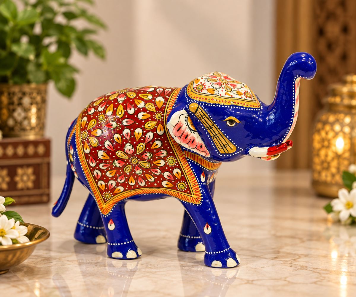 Royal blue Meenakari painted metal elephant with raised trunk and red floral detailing