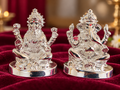Rajat Aashirwad Lakshmi Ganesh idol pair with silver-toned finish on burgundy velvet.