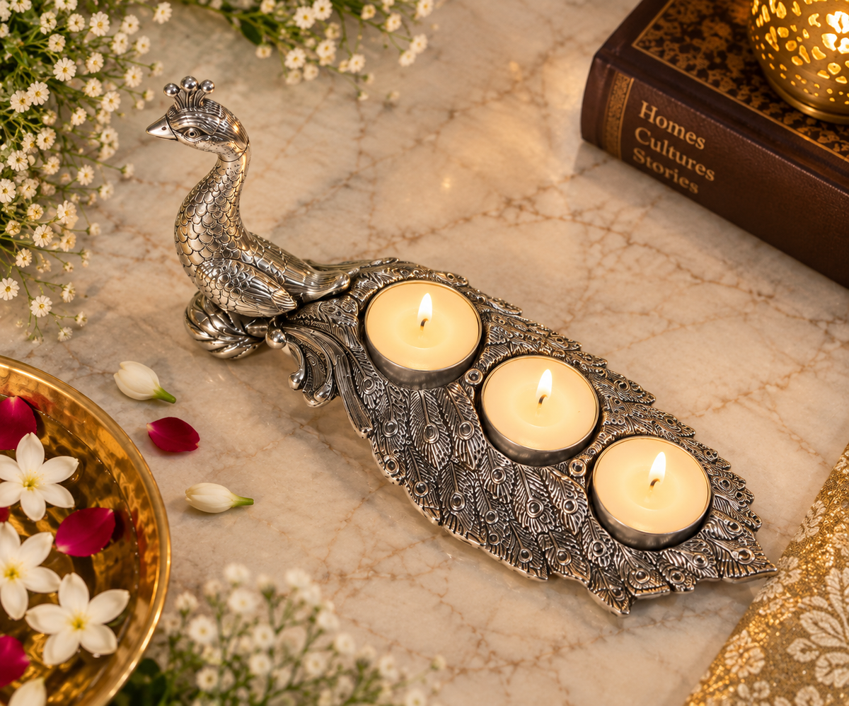 Overhead view of peacock feather detailing and three tealights