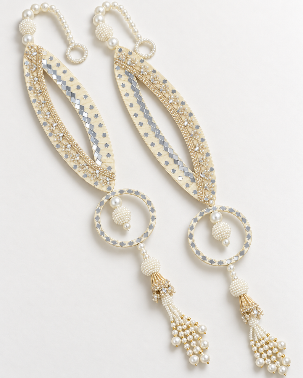 Handmade cream fish-eye latkans with reflective accents and pearl-like tassels