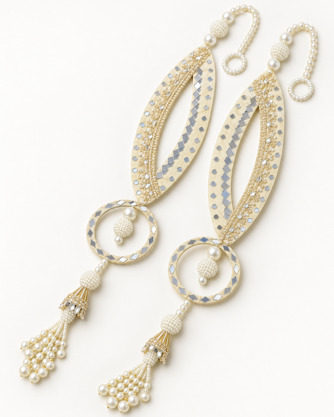Handmade cream fish-eye latkans with reflective accents and pearl-like tassels