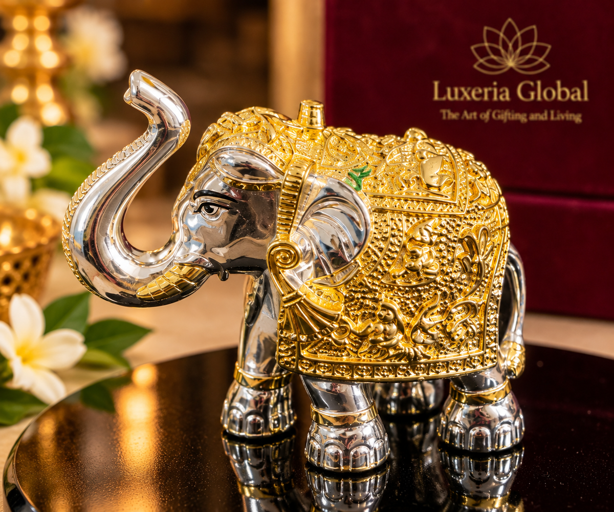 Detailed larger elephant in gold and silver polish with raised trunk and ornate motifs