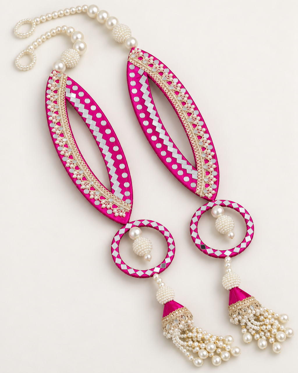 Handmade pink fish-eye latkans with reflective accents and pearl-like tassels