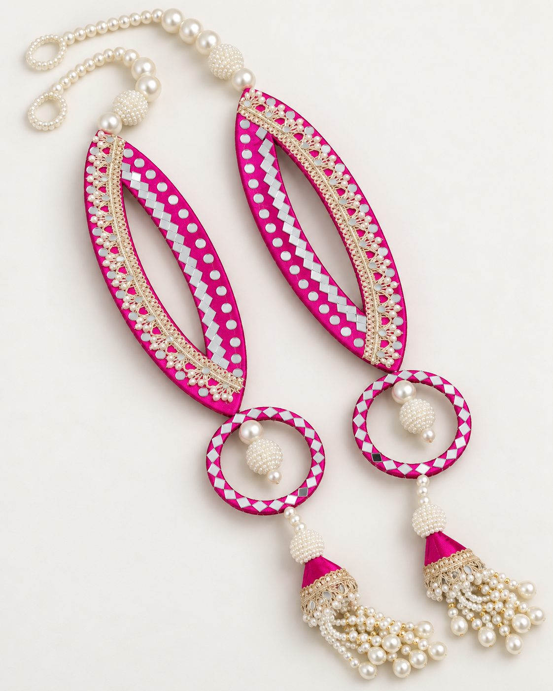 Handmade pink fish-eye latkans with reflective accents and pearl-like tassels