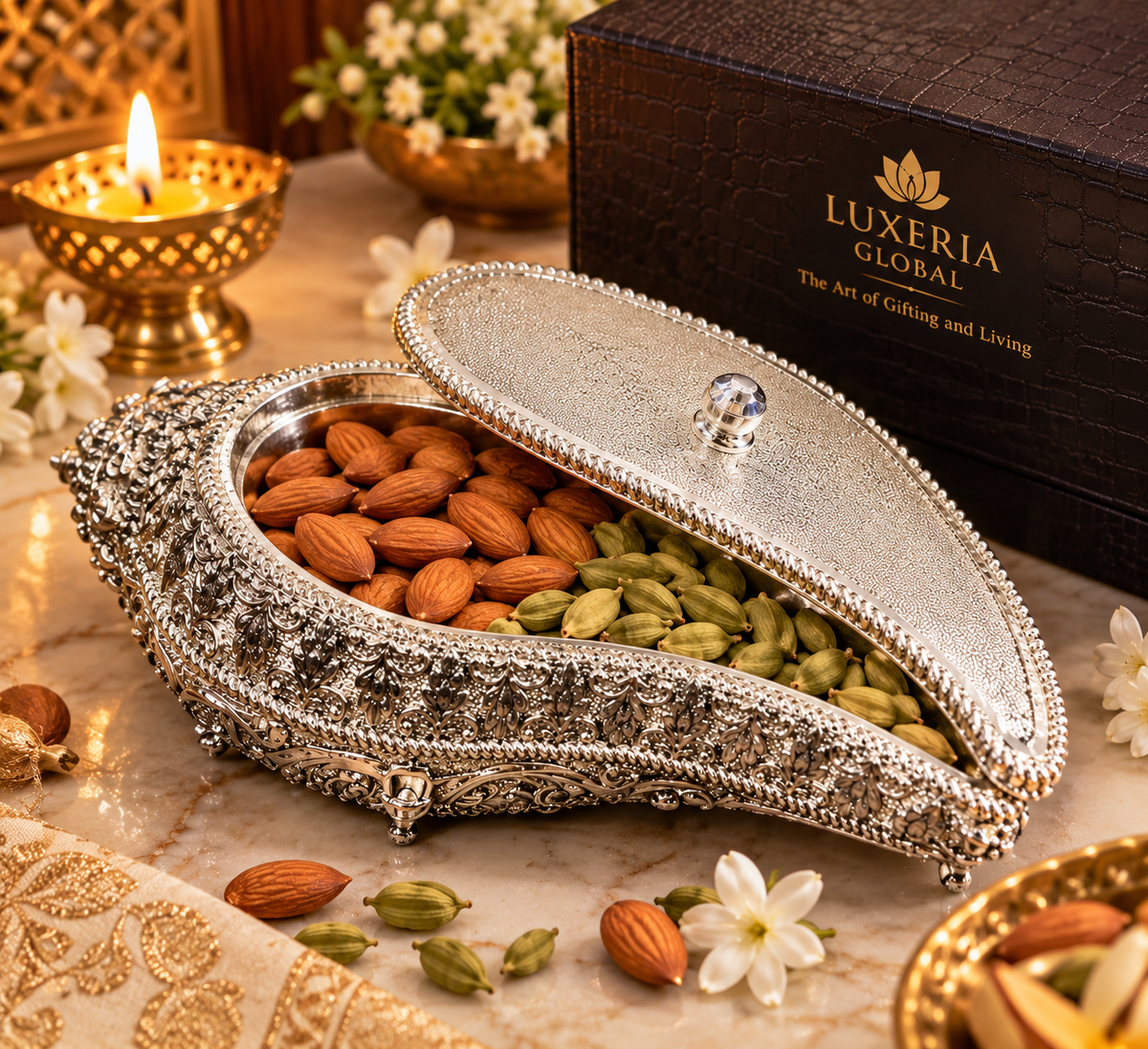 Open shankh-shaped tray styled with almonds and cardamom; contents optional