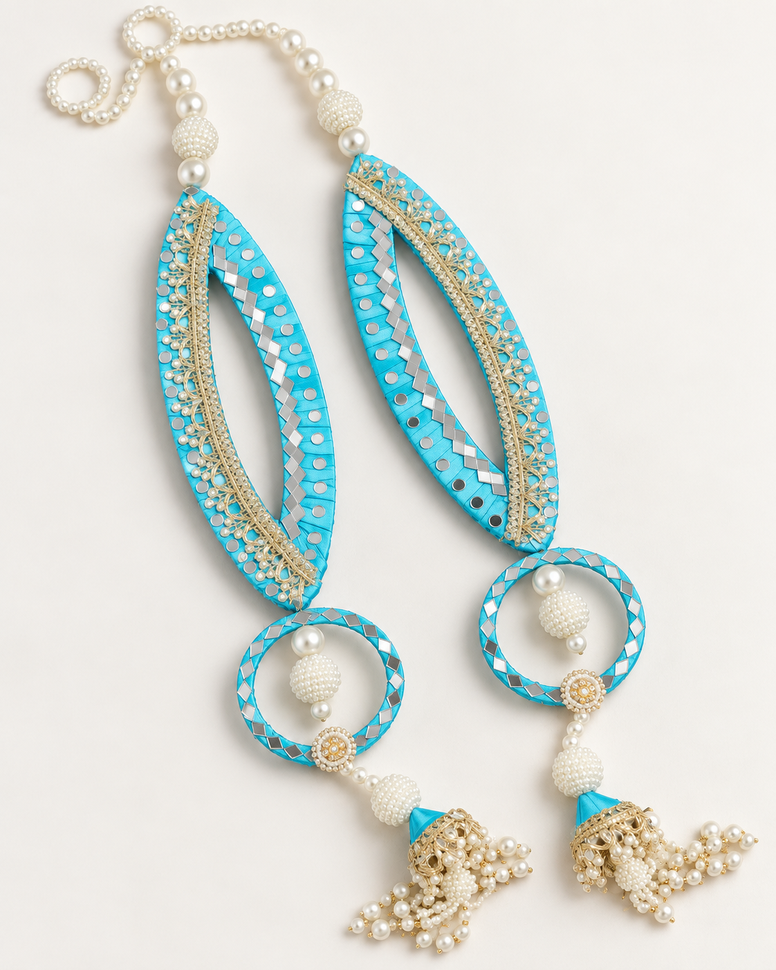 Handmade turquoise fish-eye latkans with reflective accents and pearl-like tassels