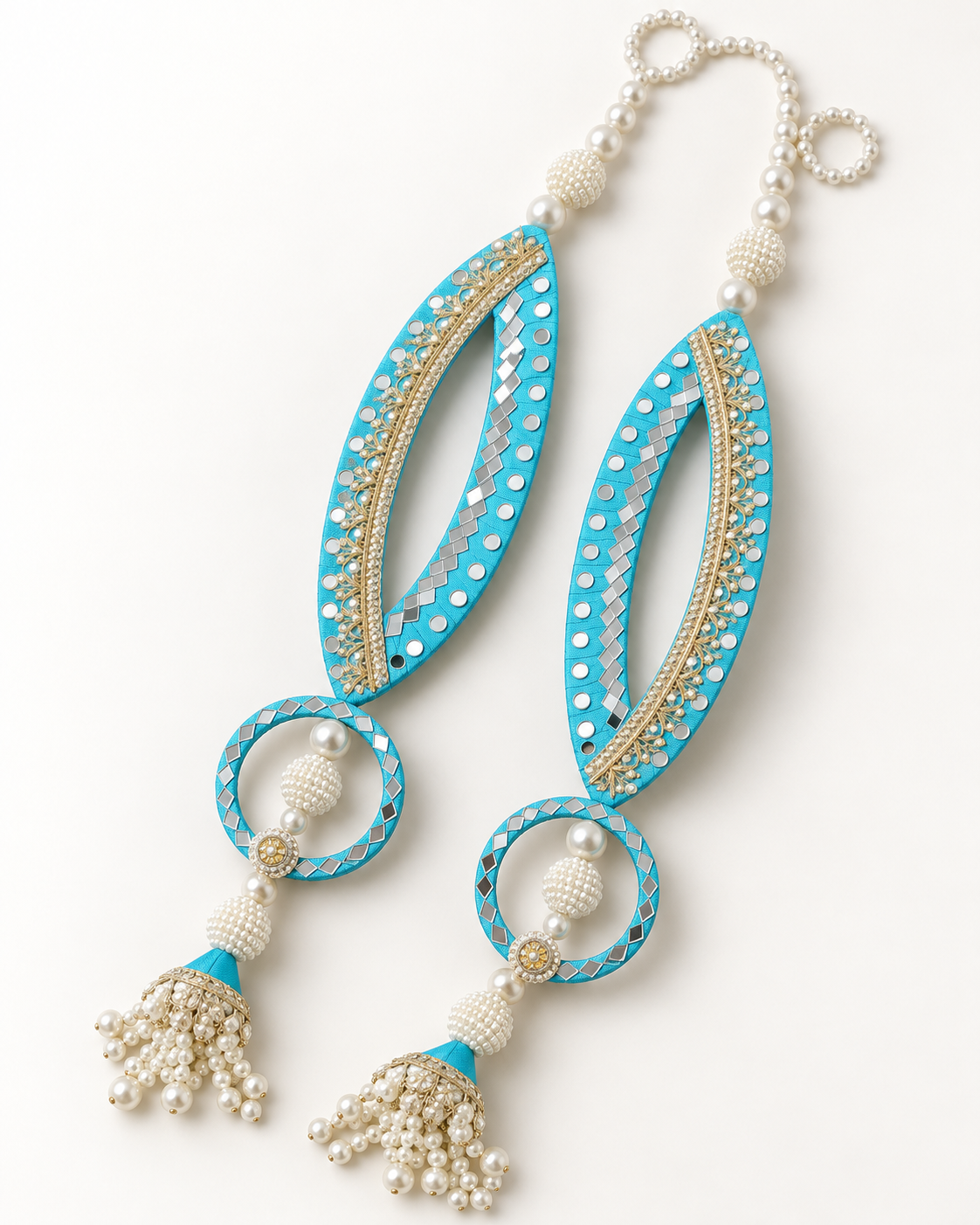 Handmade turquoise fish-eye latkans with reflective accents and pearl-like tassels